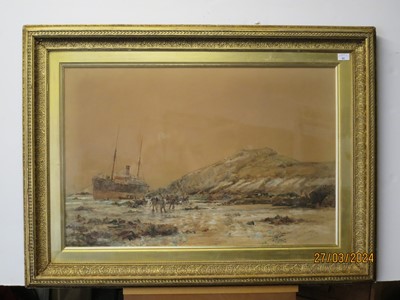 Lot 62 - CHARLES EDWARD DIXON (BRITISH, 1872-1934) - A COASTAL STRANDING, WITH LOCAL INHABITANTS ON THE FORESHORE TRYING TO ASSIST